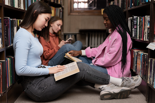 Students reading together in library as a part of a reading program